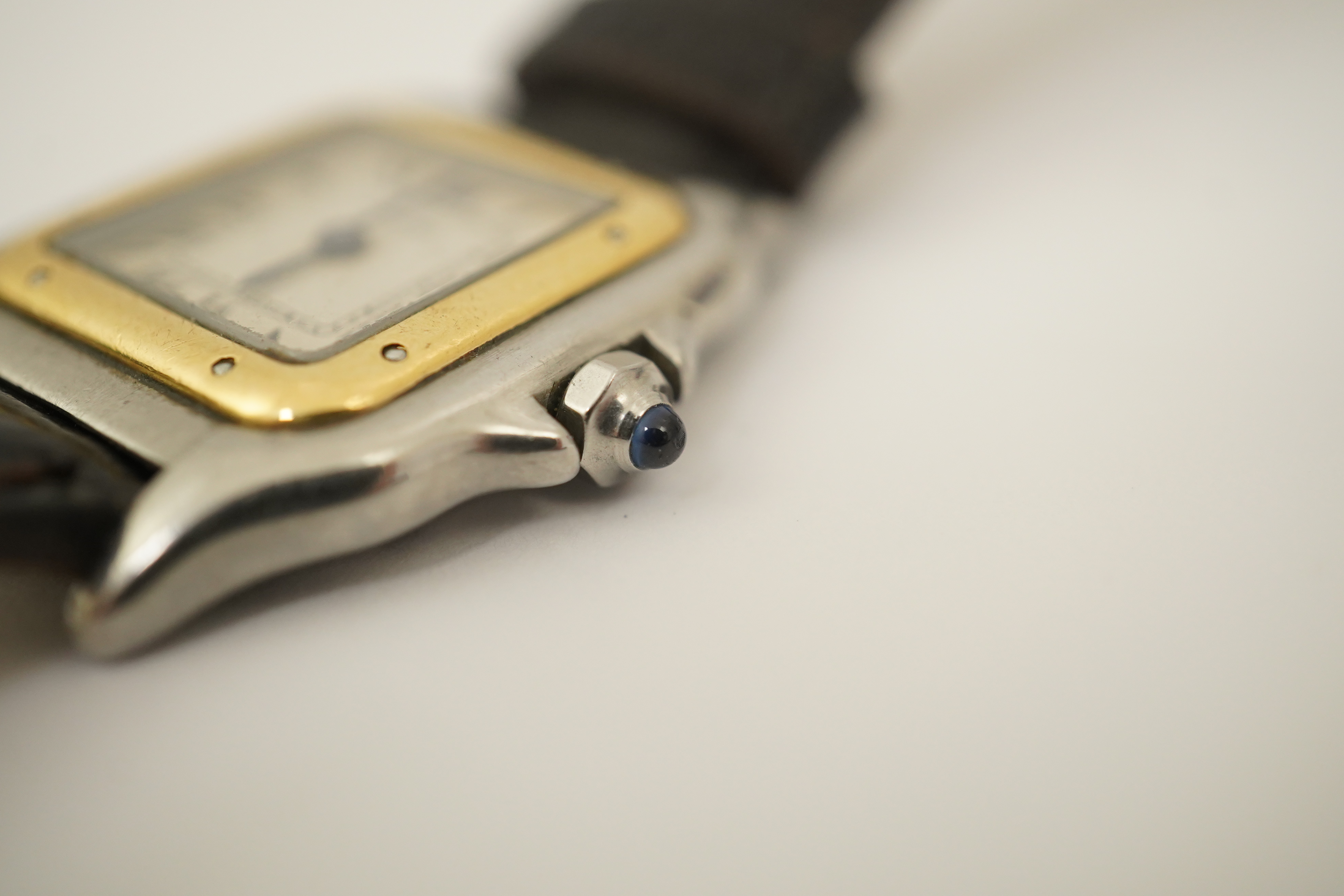 A lady's steel and gold Cartier Panthere quartz wrist watch, now on an associated leather strap, but with original Cartier steel and gold bracelet (lacking end bars)